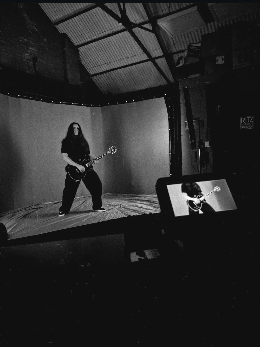 Behind the scenes on the Westlife 25 shoot: the guitarist posed with his electric guitar on the studio set, a monitor showing the live shot